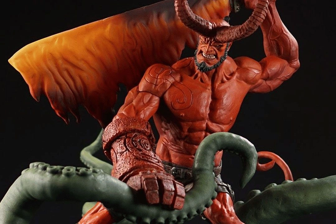 Hellboy figurine, a muscular red-skinned character with horns and a tail, confronting a tentacled monster.