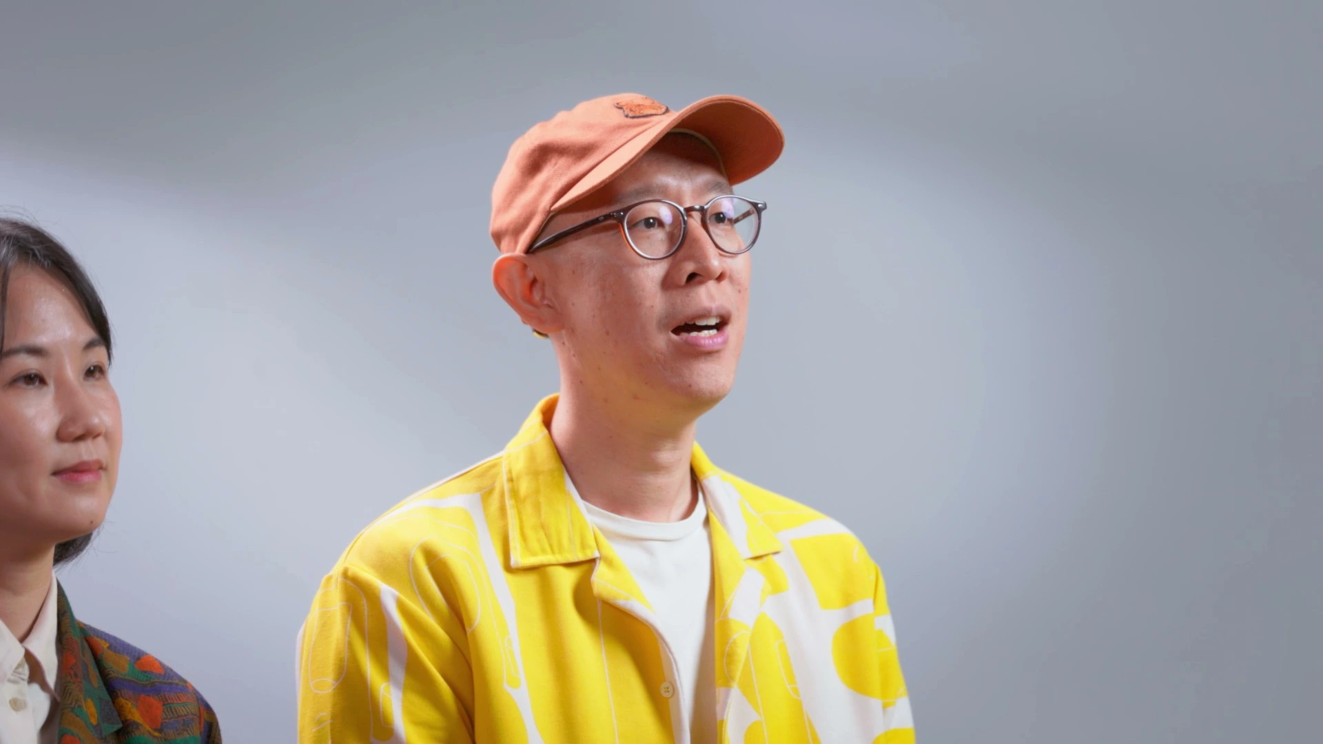 Martin and Shin from PopandStrange discussing the rebranding process as lead designers, sharing their creative insights.