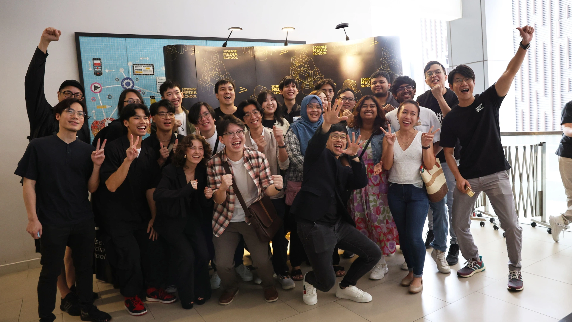 3dsense Media School students and lecturers celebrate together at graduation, posing with joyful expressions.