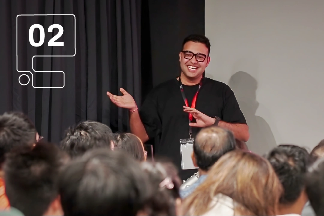 A speaker gestures animatedly in front of an engaged audience at 3dsense Open House.