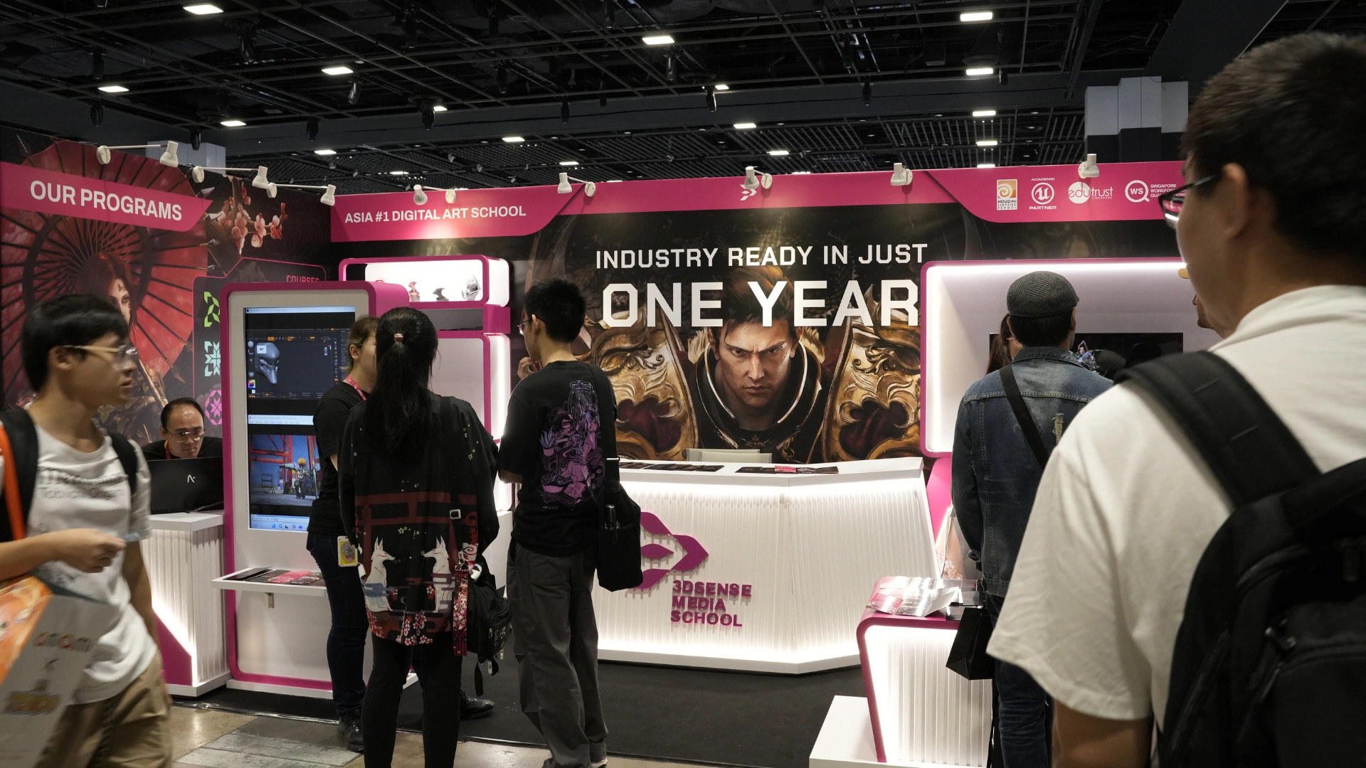 A vibrant exhibition booth promoting 3dsense, showcasing digital art programs with colorful graphics and engaging displays.