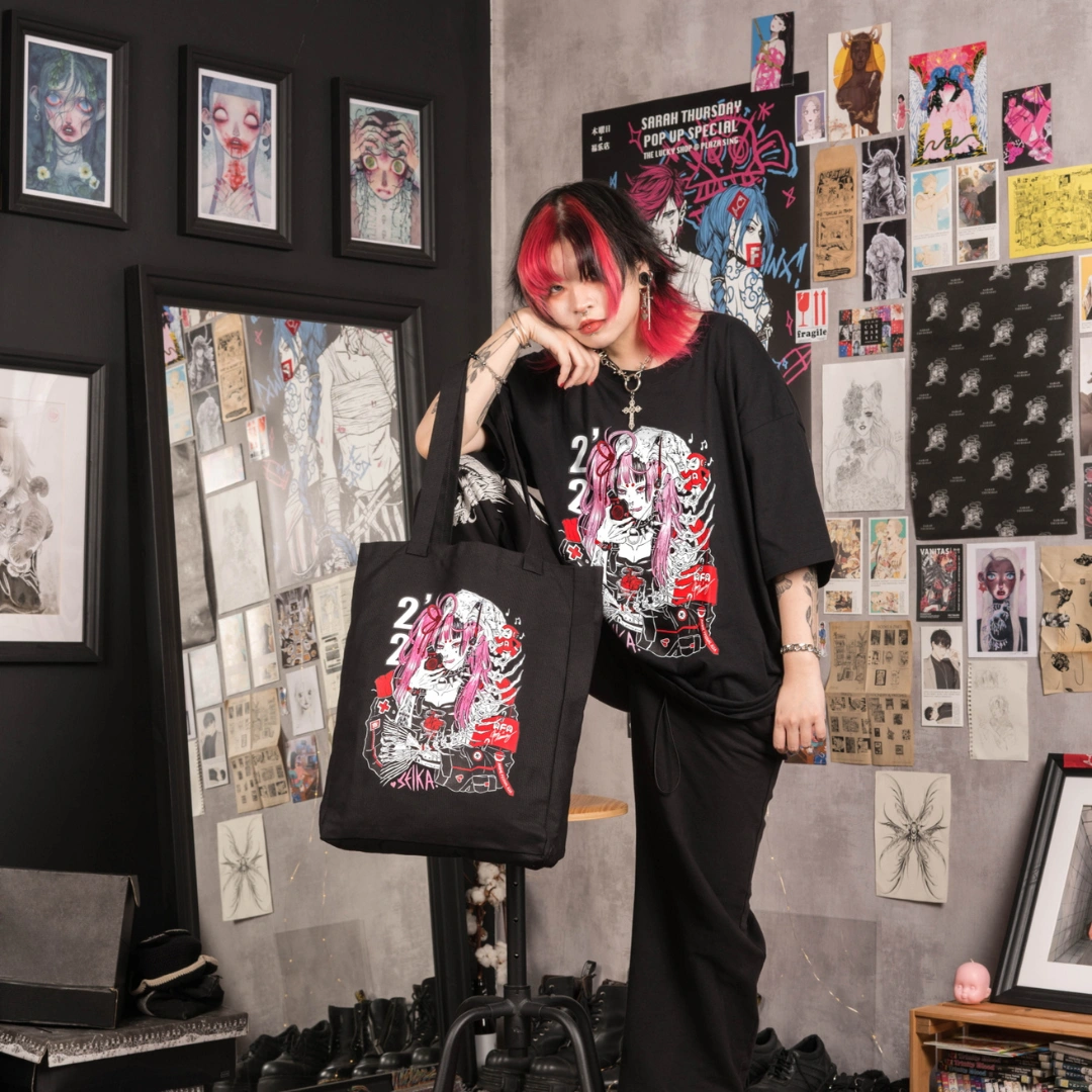 A group of people engage in conversation in a creative workspace decorated with colorful artwork and computers.