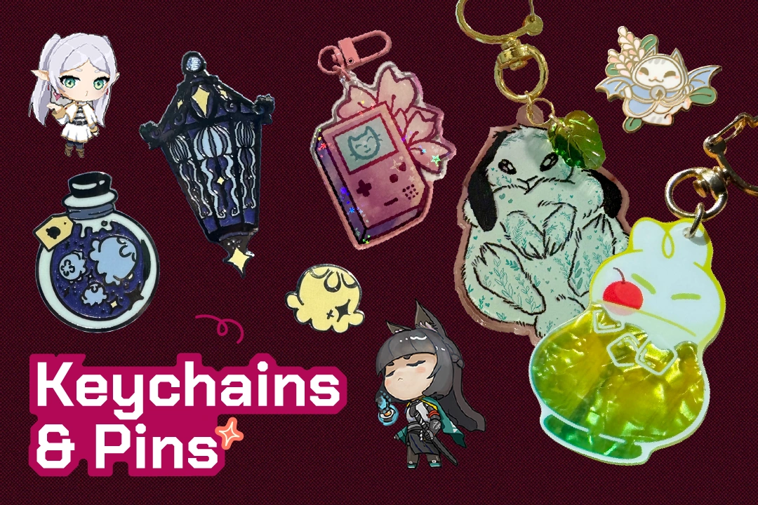 A colorful assortment of keychains and pins featuring cute characters, lanterns, and game consoles on a maroon background.
