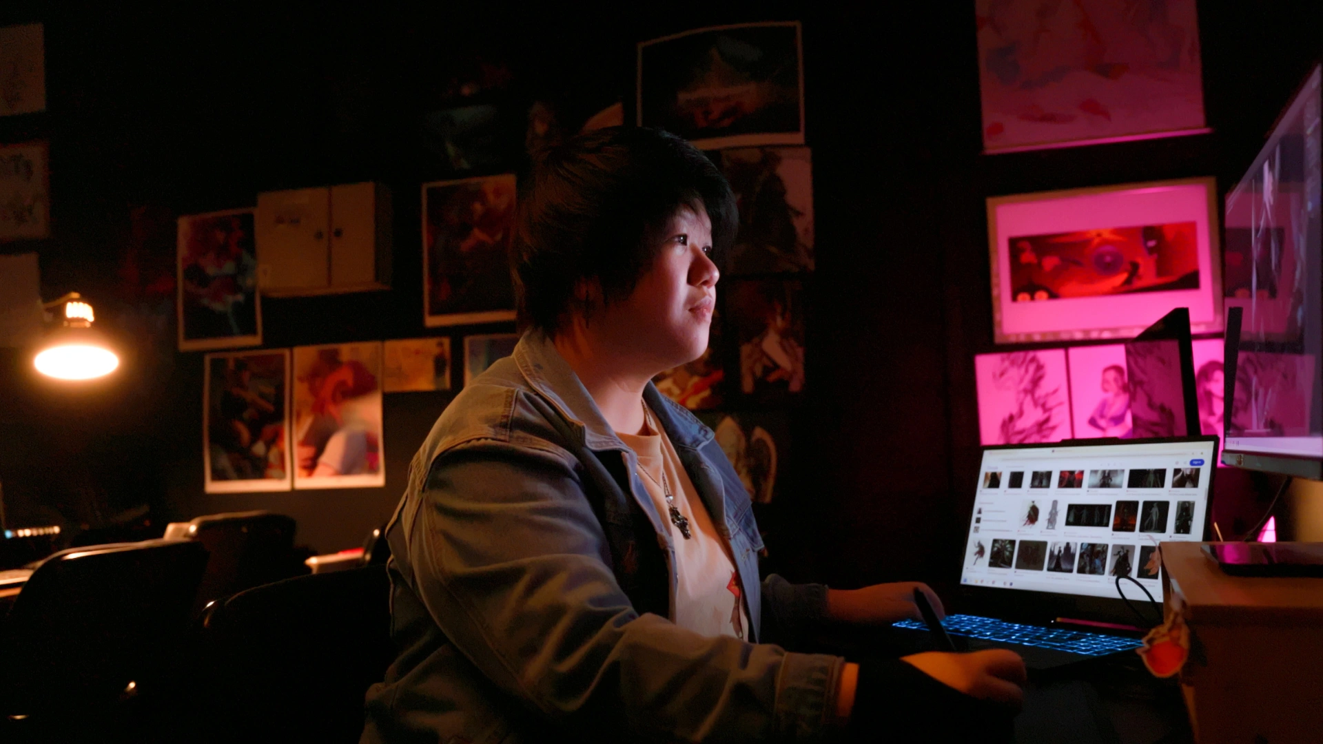 Bel, 3dsense Media School alumnus, working on a Wacom tablet and screen creating concept art.