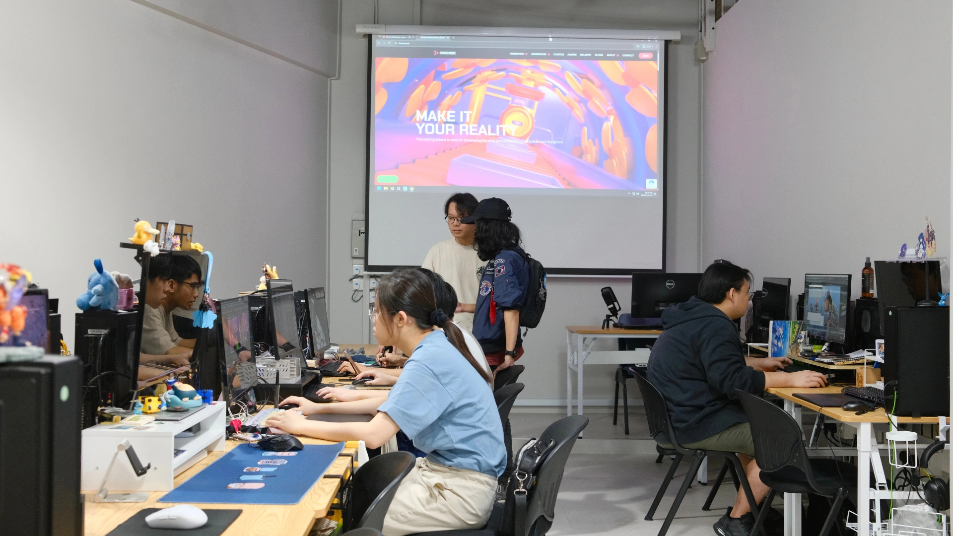 Animation students at 3dsense Media School working on 3D projects in a studio classroom environment.