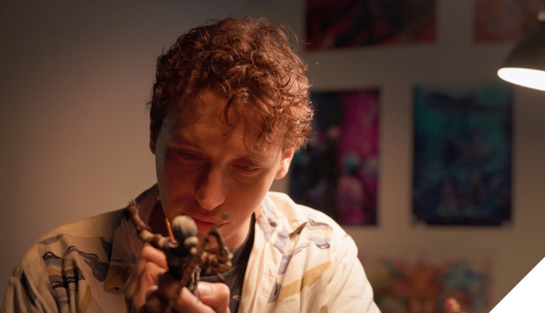 3dsense student sculpting his figurine at his desk station.